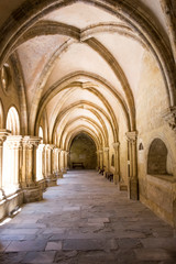 Portugal, Coimbra. Old Cathedral cloister. Archways, walking paths, courtyard.