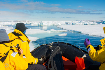 Norway. Svalbard. Strait. Zodiac cruising in the drift ice. © Inger Hogstrom/Danita Delimont