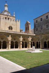 Fototapeta premium Portugal, Coimbra. Old Cathedral cloister. Archways, walking paths, courtyard.