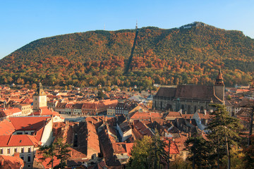 Romania, Brasov. City signage. Poarta Schei district. Looking out over forested park and hill side near the Tampa Mountain area.