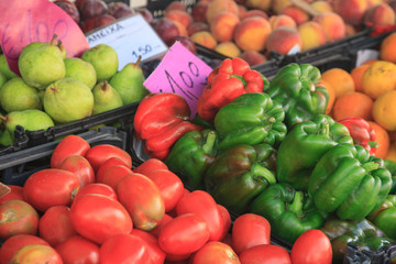 Bins of fresh fruits and vegetables for sale in open air market