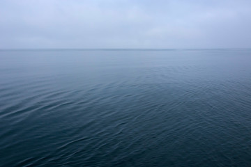 Obraz premium Norway. Svalbard. Nordaustlandet Island. Calm water and cloudy skies.