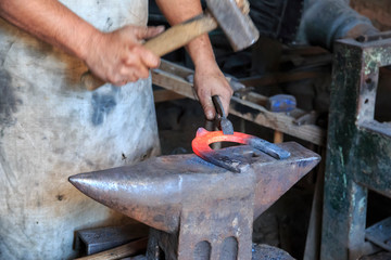 Romania, Transylvania, Carpathian Mountains, Viscri. Blacksmith, horse-shoeing, tools of the trade.