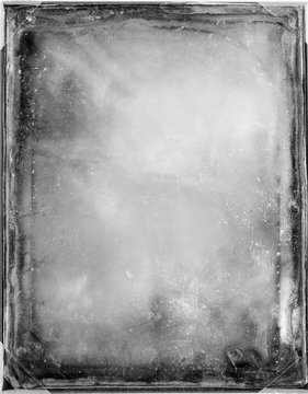 Weathered black and white frame with white dots and defects