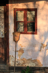 Romania, Maramures, Baia Spire, Guest house Casa Olarului. Pottery workshop. Broom leaning on house.