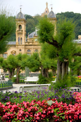 Spain, San Sebastian. Popular seaside resort, park view of historic casino.