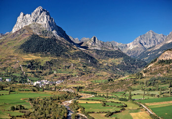 Spain, Sallent de Gallego. A small village nestles at the foot of these jagged peaks near Sallent de Gallego in the Pyrenees Mountains, Spain.