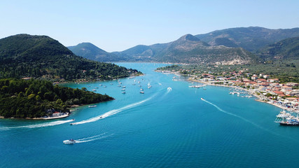 Naklejka premium Aerial drone bird's eye view photo of iconic port of Nidri or Nydri a safe harbor for sail boats and famous for trips to Meganisi, Skorpios and other Ionian islands, Leflkada island, Ionian, Greece