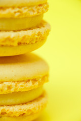 Fototapeta na wymiar Two yellow macarons on yellow background