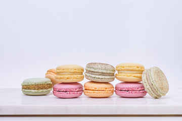 Few colored macarons on a white background