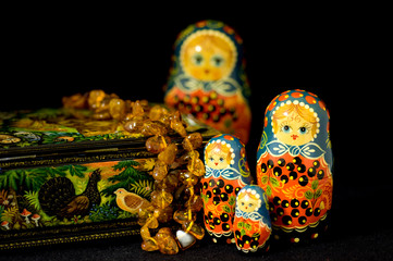 Russia, Russian handicrafts. High quality traditional painted lacquer box, matryoshka dolls & amber necklace.