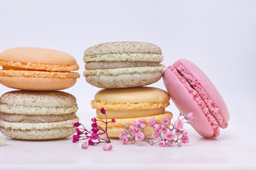 Few colored macarons on a white background
