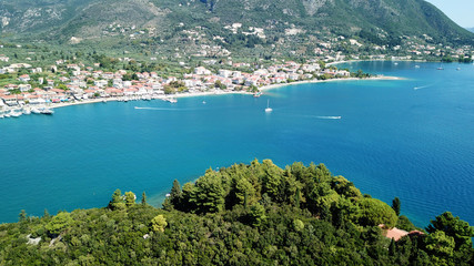 Naklejka premium Aerial drone bird's eye view photo of iconic port of Nidri or Nydri a safe harbor for sail boats and famous for trips to Meganisi, Skorpios and other Ionian islands, Leflkada island, Ionian, Greece