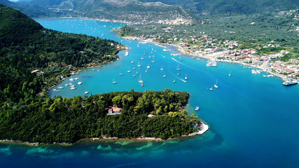 Fototapeta premium Aerial drone bird's eye view photo of iconic port of Nidry or Nydri a safe harbor for sail boats and famous for trips to Meganisi, Skorpios and other Ionian islands, Leflkada island, Ionian, Greece