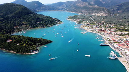 Naklejka premium Aerial drone bird's eye view photo of iconic port of Nidry or Nydri a safe harbor for sail boats and famous for trips to Meganisi, Skorpios and other Ionian islands, Leflkada island, Ionian, Greece