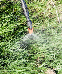 Spraying herbicide from the nozzle of the sprayer manual