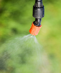 Spraying herbicide from the nozzle of the sprayer manual