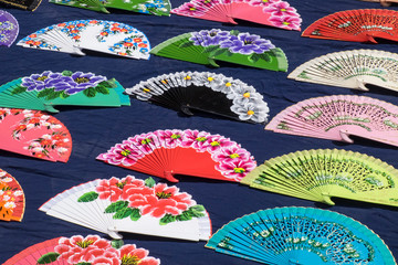 Spain, Andalusia, Seville. Hand-painted personal fans on display for sale.