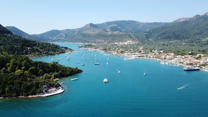 Fototapeta na wymiar Aerial drone bird's eye view photo of iconic port of Nidry or Nydri a safe harbor for sail boats and famous for trips to Meganisi, Skorpios and other Ionian islands, Leflkada island, Ionian, Greece
