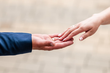 Bride and groom hands drawning to each other