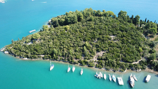 Aerial drone photo of iconic uninhabited island of Madouri in bay of Nydri and Mansion of 19th-century poet Aristotelis Valaoritis, Lefkada, Ionian, Greece