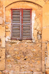 Fototapeta premium Spain, Balearic Islands, Mallorca. Wood shuttered window.