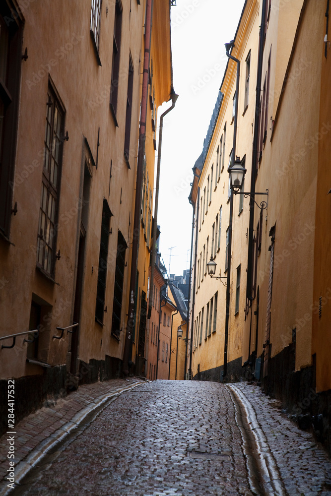 Poster Stockholm, Sweden - A narrow alley going between two old world buildings.