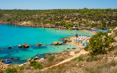  blue sea with clear water, mountains, yachts and the beach on the panorama of Konnos Bay Cyprus
