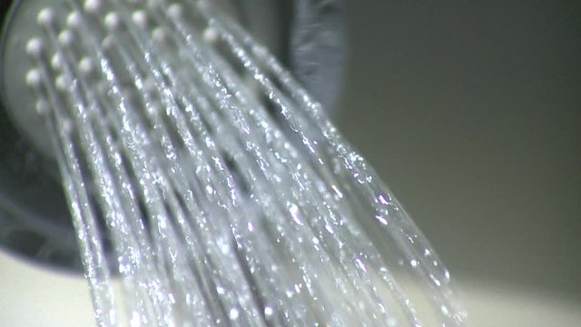 Water shoots out of shower head. (v.4)