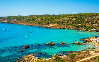  blue sea with clear water, mountains, yachts and the beach on the panorama of Konnos Bay Cyprus