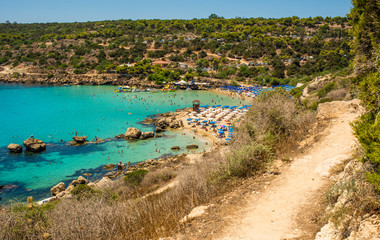  blue sea with clear water, mountains, yachts and the beach on the panorama of Konnos Bay Cyprus