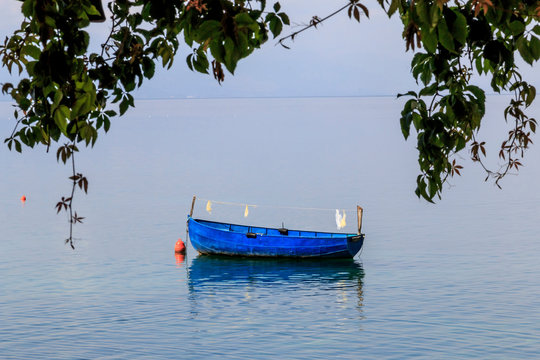 Macedonia, Ohrid and Lake Ohrid, both a UNESCO World Heritage Cultural and Natural Site. Blue fishing boat.