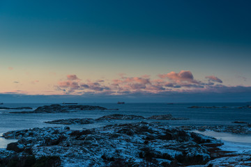 Snowy archipelago in the winter. Ships in the horizon. © Trygve