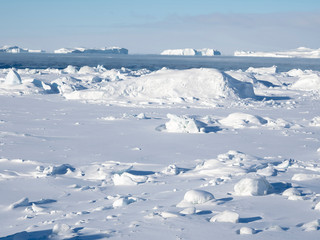 Fototapeta na wymiar Frozen Disko Bay with icebergs at the Ilulissat Icefjord. The icefjord is listed as UNESCO World Heritage Site. Greenland, Denmark.