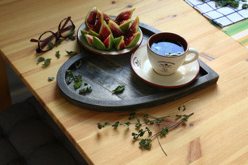 tea beautiful tray on the wood table. glass and fig. countryside style