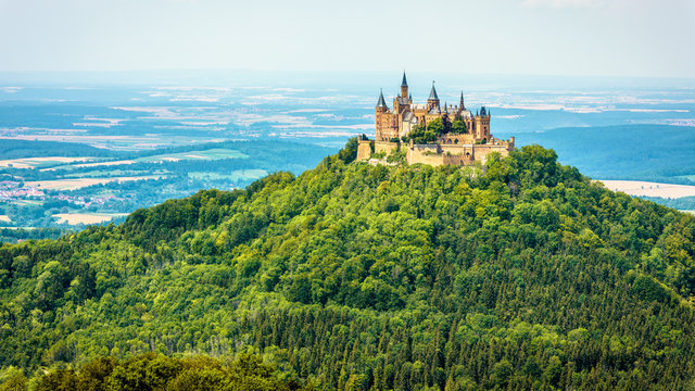 Hohenzollern Castle on mountain top, Germany. This castle is a famous landmark in vicinity of Stuttgart. Scenic panorama of Burg Hohenzollern in summer. Landscape of Swabian Alps with Gothic castle.