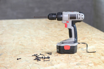 screwdriver and screws on osb plywood