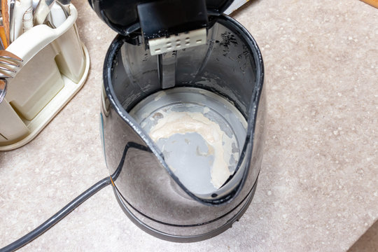 Limescale, lime scale in old kettle in kitchen. A white, chalky residue of calcium carbonate. Household appliances repair caused by hard water