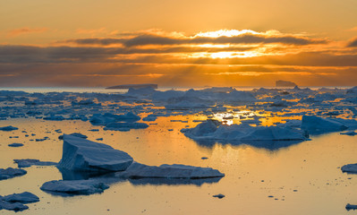Ilulissat Icefjord also called kangia or Ilulissat Kangerlua, sunset over Disko Bay. The icefjord...