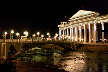 Obraz premium Central Balkan Peninsula, The Macedonia, Skopje, Ministry of Foreign Affairs and the Eye Bridge, a pedestrian bridge, Vardar River, between Stone Bridge and the Art Bridge, includes 28 sculptures .