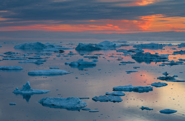 Ilulissat Icefjord also called kangia or Ilulissat Kangerlua, sunset over Disko Bay. The icefjord...