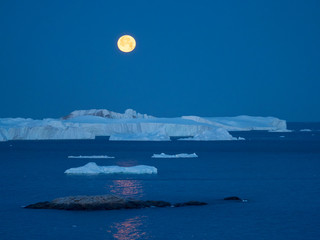 Full Moon. Ilulissat Icefjord also called kangia or Ilulissat Kangerlua at Disko Bay. The icefjord...