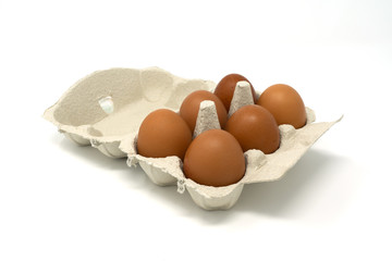 some beautiful eggs in their carton box on a white background