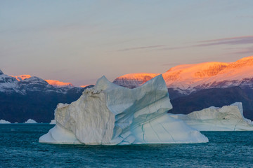 Greenland. Scoresby Sund. Gasefjord. Sunrise on the mountains with icebergs.