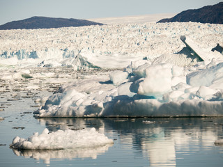 Icebergs in the Uummannaq fjord system, northwest Greenland. Glacier Store Gletscher and the ice cap in the background.