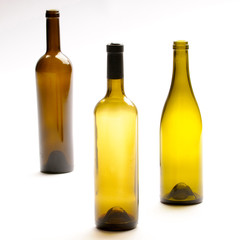 Three Empty Wine Bottles On White Background.