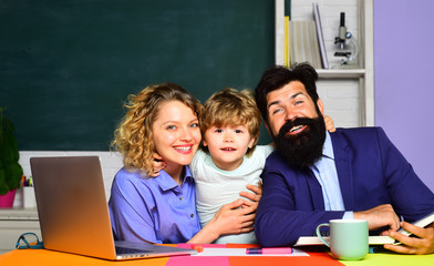 Parents helps child boy. Parents teaching kids private lessons in math. Back to school. Home schooling. Mathematics for kids. Pupil learning letters and numbers with parents. Home family schooling.