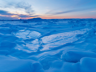Ilulissat at the frozen shore of Disko Bay. The icefjord nearby is listed as UNESCO World Heritage Site. Greenland, Denmark.