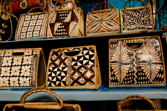 Polynesia, Kingdom of Tonga, Nuku'alofa. Decorated tapa or bark cloth handbags for sale in market.