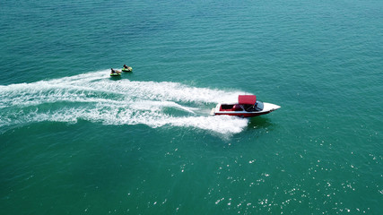 Fototapeta premium Aerial drone photo of extreme powerboat donut watersports crusing in high speed in tropical turquoise bay